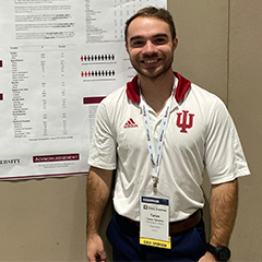 Student standing in front of a poster