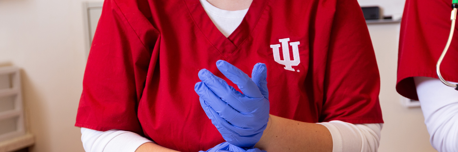 Nursing student putting on gloves