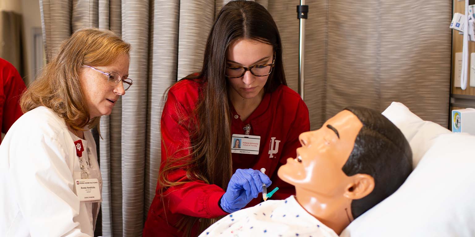 Nursing student at the Simulation and Skills Center working with instructor