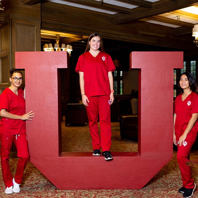 Three IU Bloomington nursing students pose at the IU trident photo op in the Indiana Memorial Union