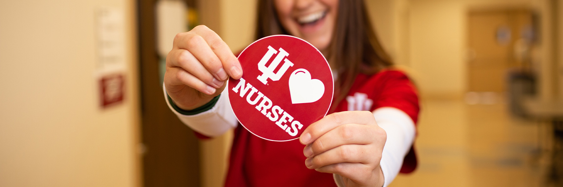 Nursing student holding I Love Nurses sticker