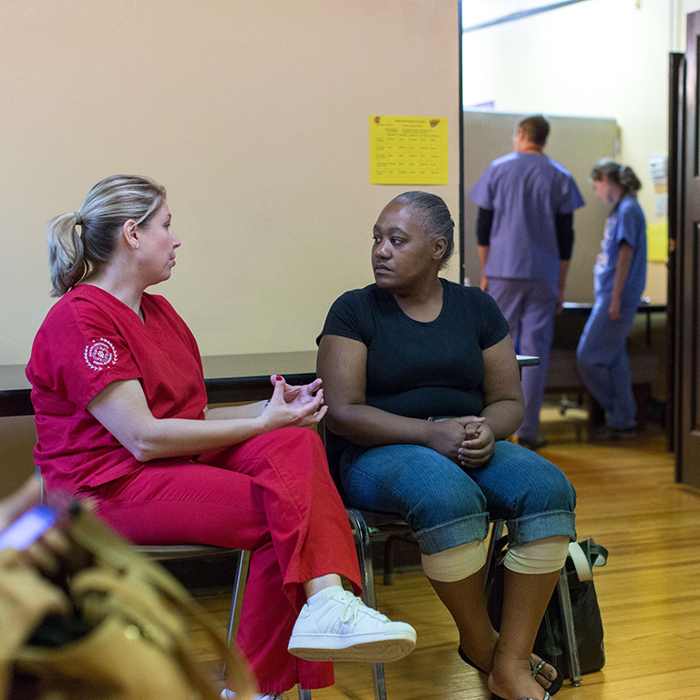 Nursing student with community member at the Eastside Clinic