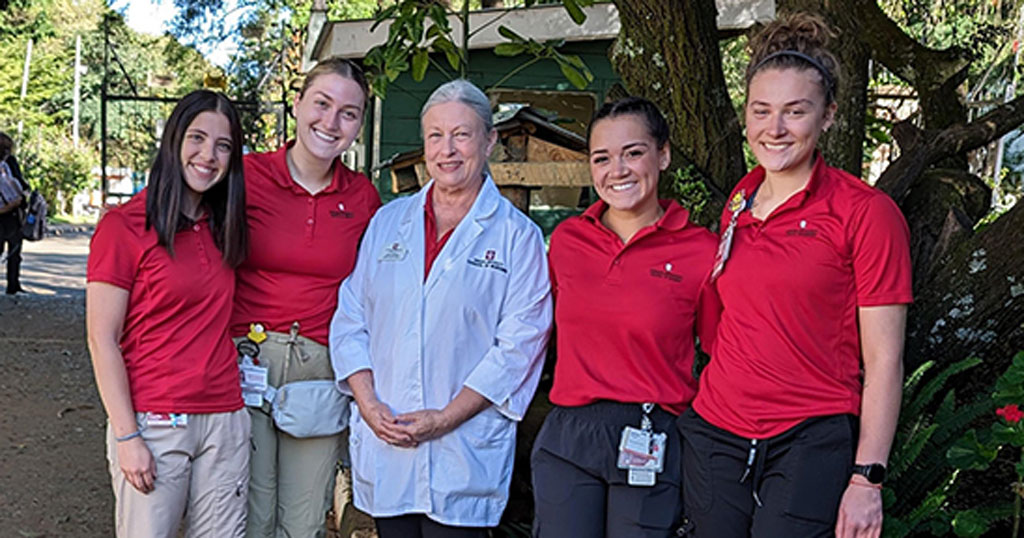 IU School of Nursing's Dr. Bethany Murray and nursing students pose for a photo during a study-abroad opportunity in Kenya