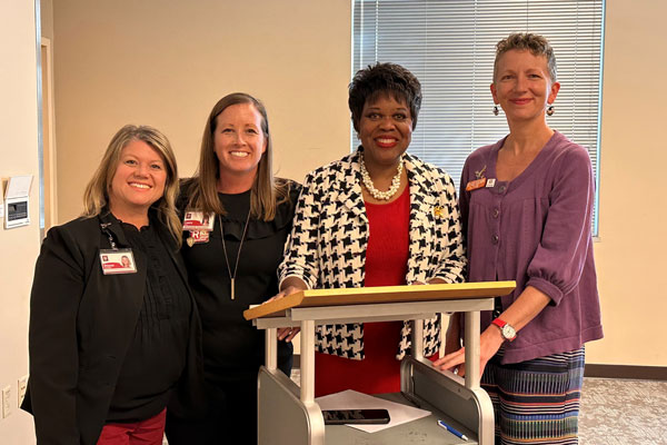 Former Eagles pose for a photo with IU School of Nursing's Dr. Sharron Crowder