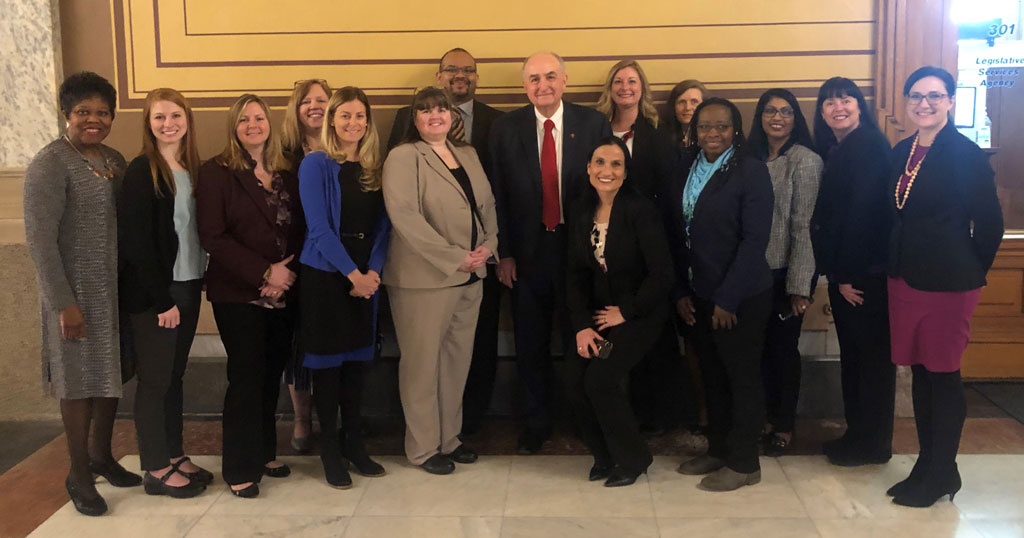 Dr. Sharron Crowder, a group of Eagles Health Policy and Advocacy and Mentoring Program participants, and legislators pose for a photo at the Indiana Statehouse