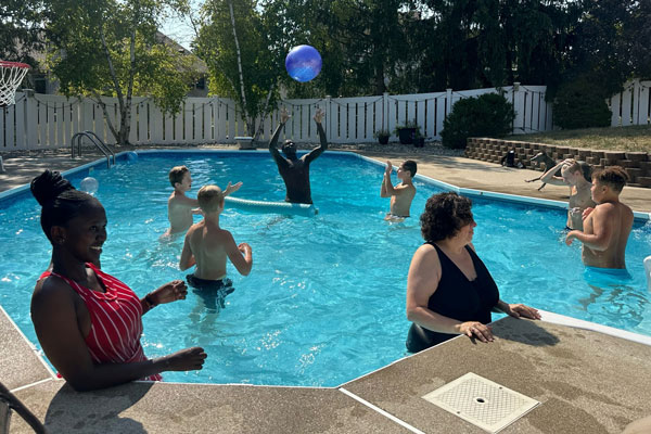 Moi University students Victor Kiplagat and Olivia Watta and others cool off during a day at the pool in Fort Wayne.