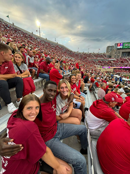 Moi University students Victor Kiplagat and Olivia Watta attend an IU football game at Memorial Stadium in Bloomington.