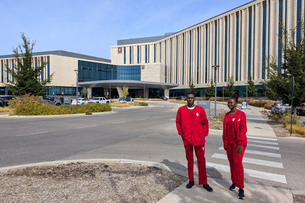 Moi University students Victor Kiplagat and Olivia Watta pose for a photo outside of IU Health Bloomington.