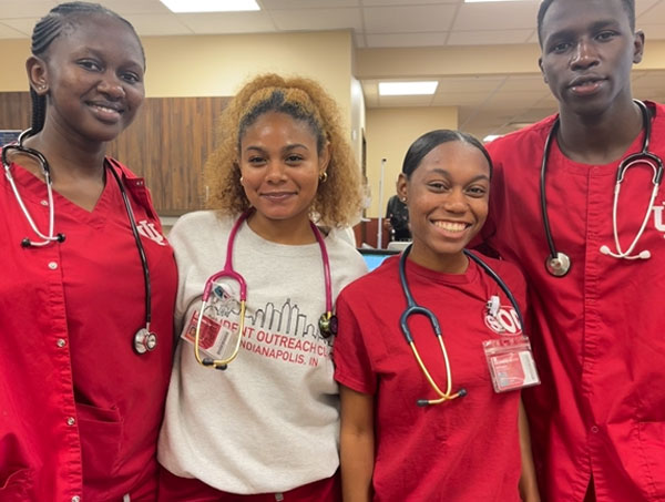 Moi University students Olivia Watta and Victor Kiplagat pose for a photo with IU School of Nursing students at the Student Outreach Clinic in Indianapolis.