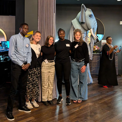 Moi University students Victor Kiplagat and Olivia Watta pose for a photo with IU School of Nursing students during AMPATH's Tusker Tales.