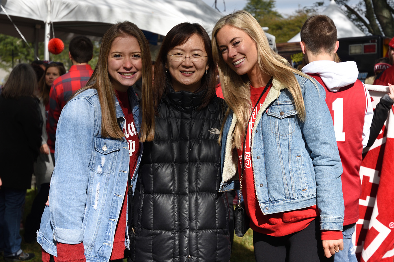 Three women smiling for camera at homecoming