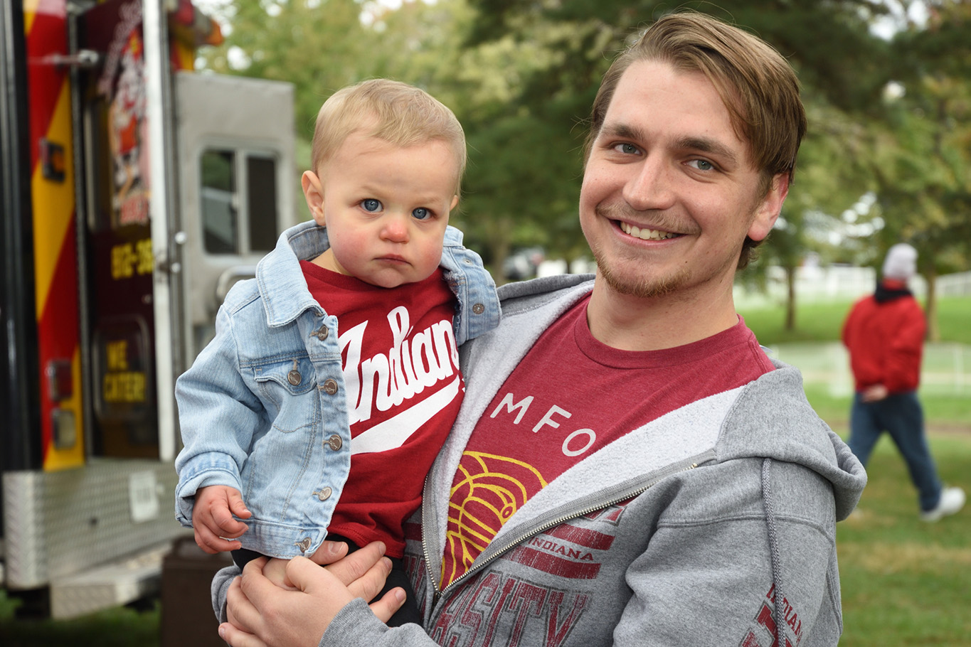 man with baby at homecoming