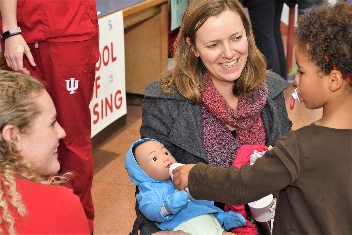 Children with student nurses and baby manikin at Science Fest