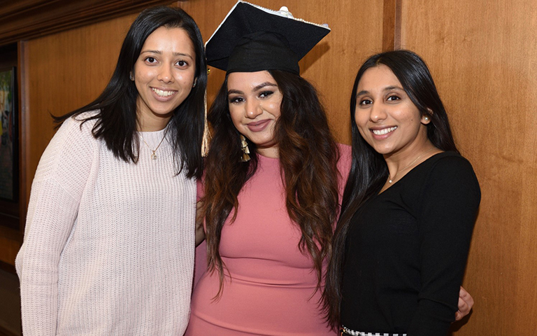 Graduate posing with family