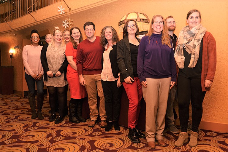 Group of people standing in a line facing the camera