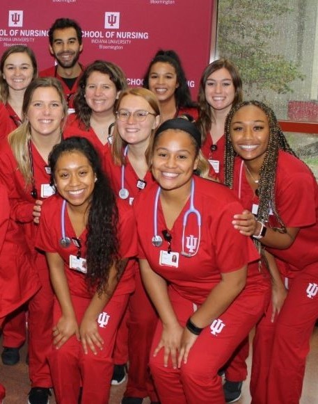 Group of IUSON students in red scrubs