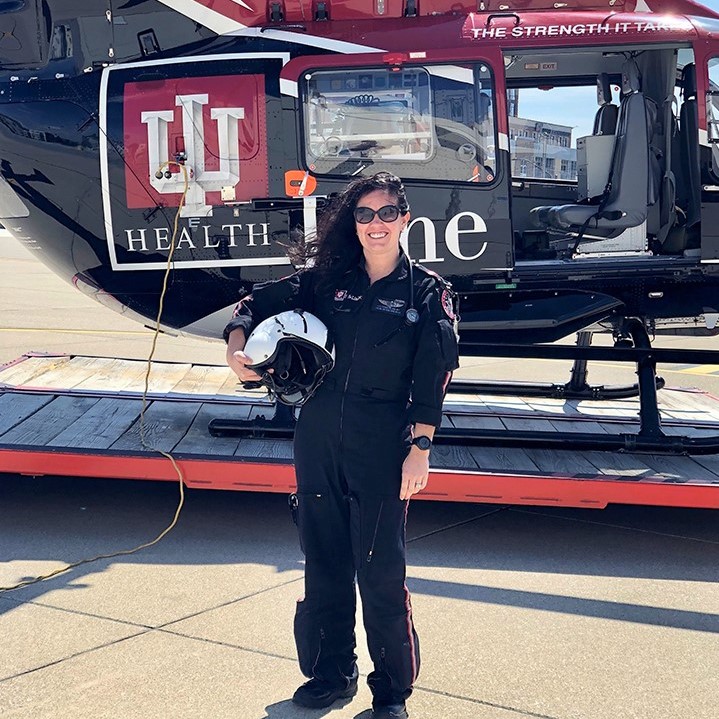 Kate Pedigo standing in front of Lifeline helicopter
