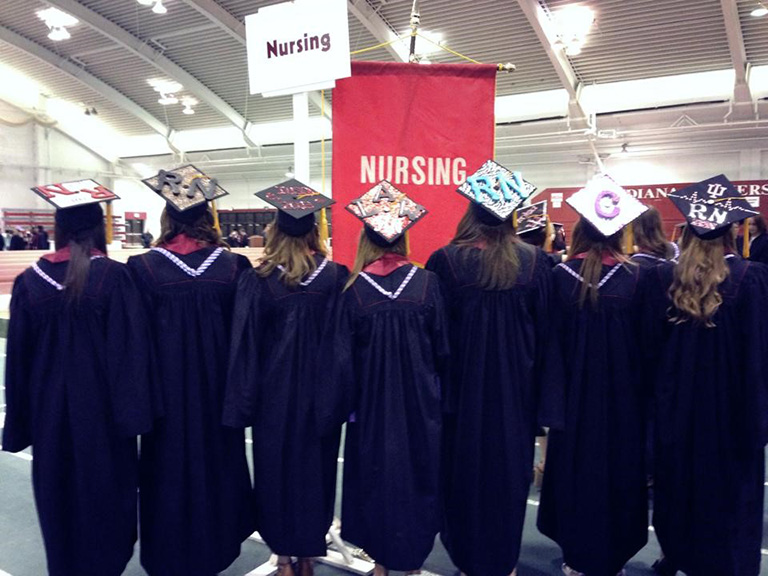 Row of graduates in caps and gowns