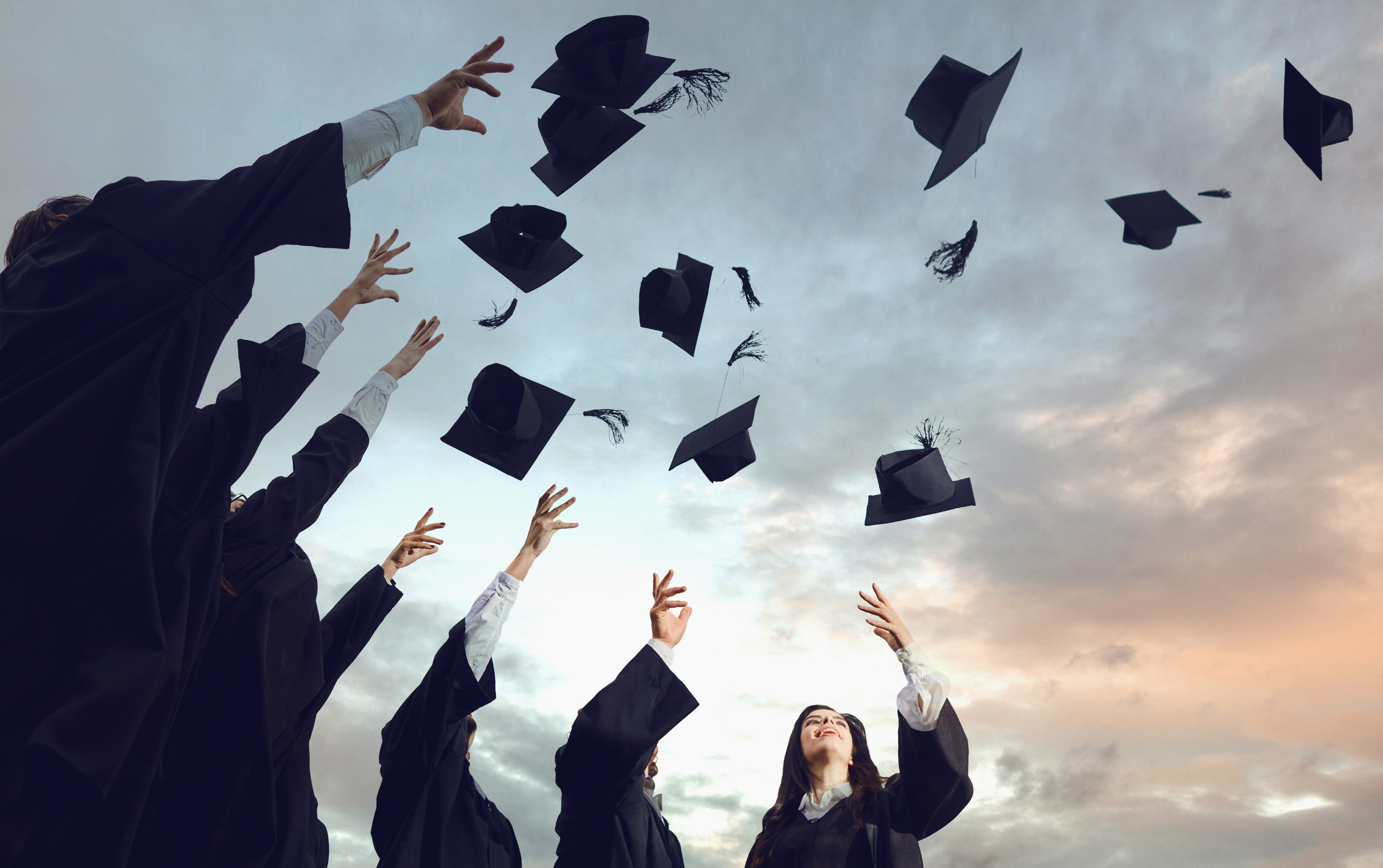 Mortarboards against the sky after having been tossed