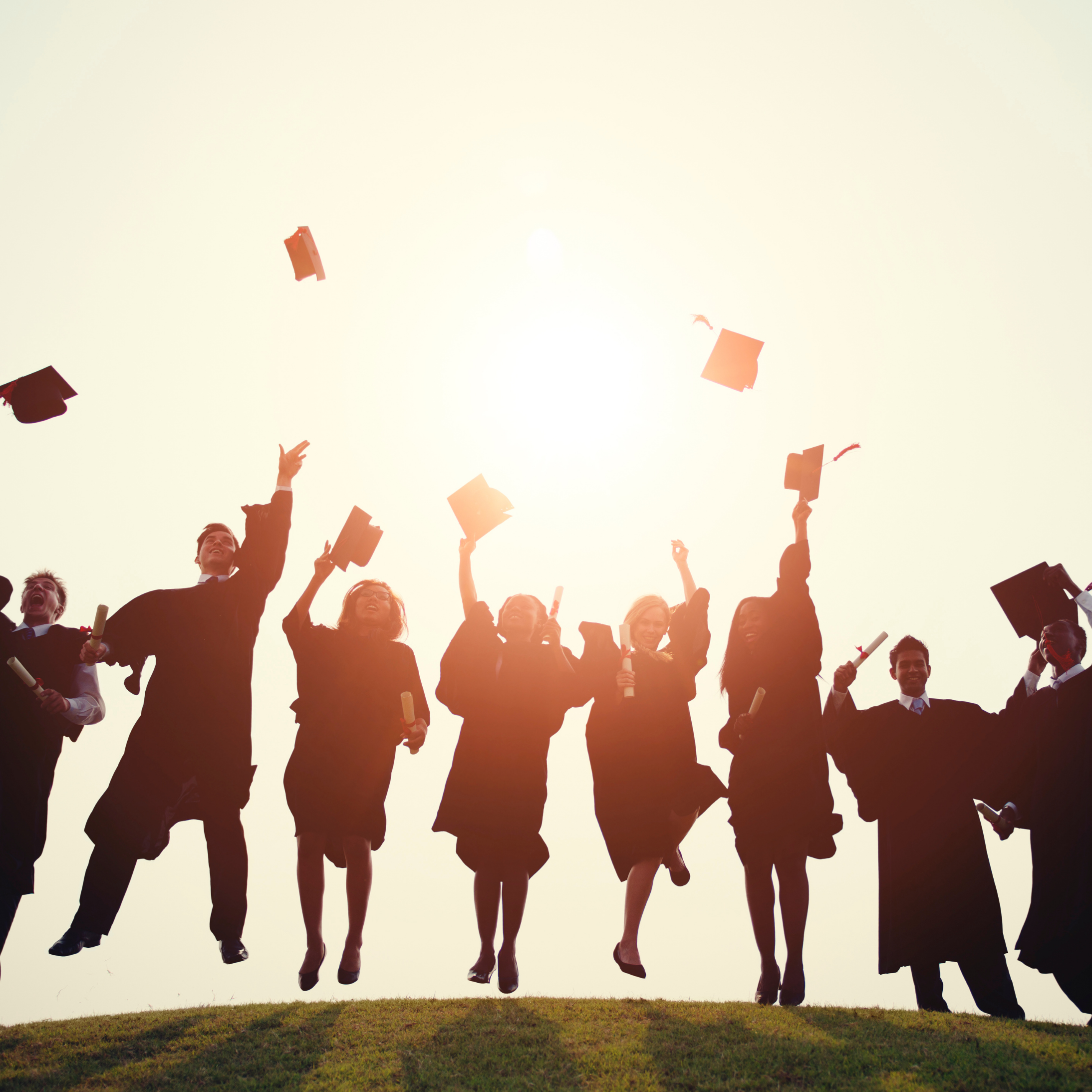 Illustration of graduates in gowns throwing caps in air