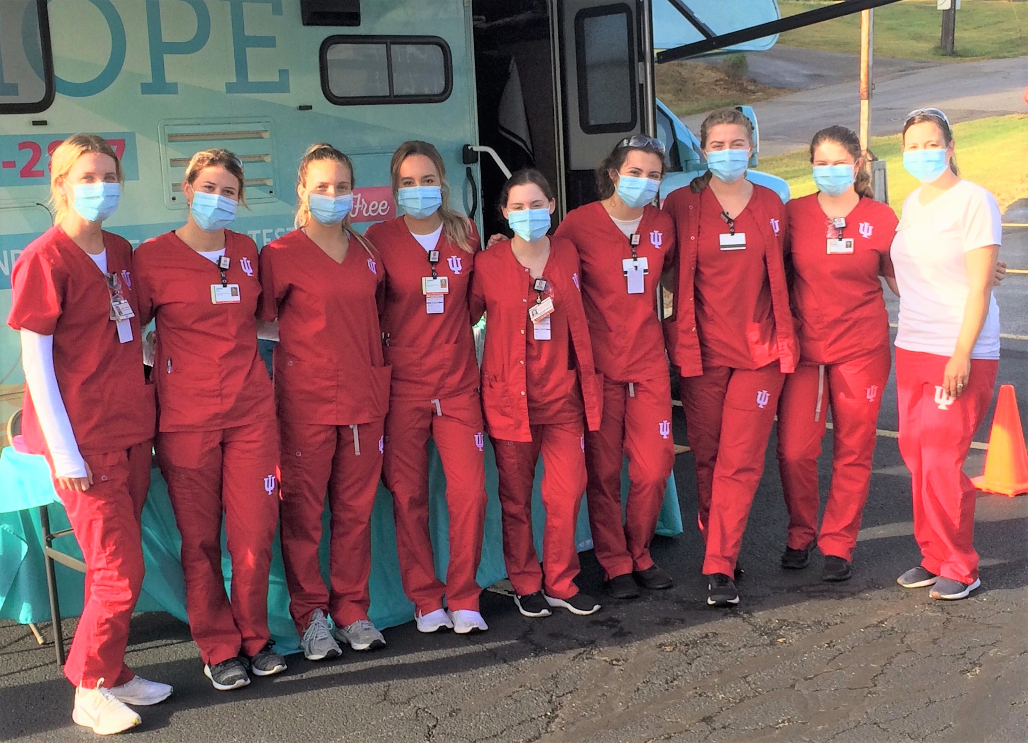 Group of students in red scrubs