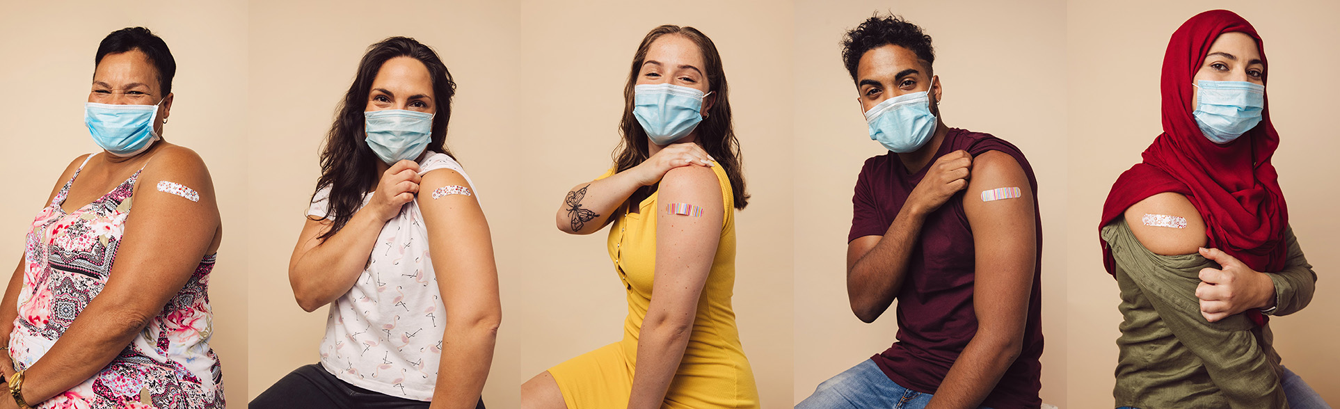 A row of people wearing protective masks and showing an adhesive bandage on their arm after vaccination