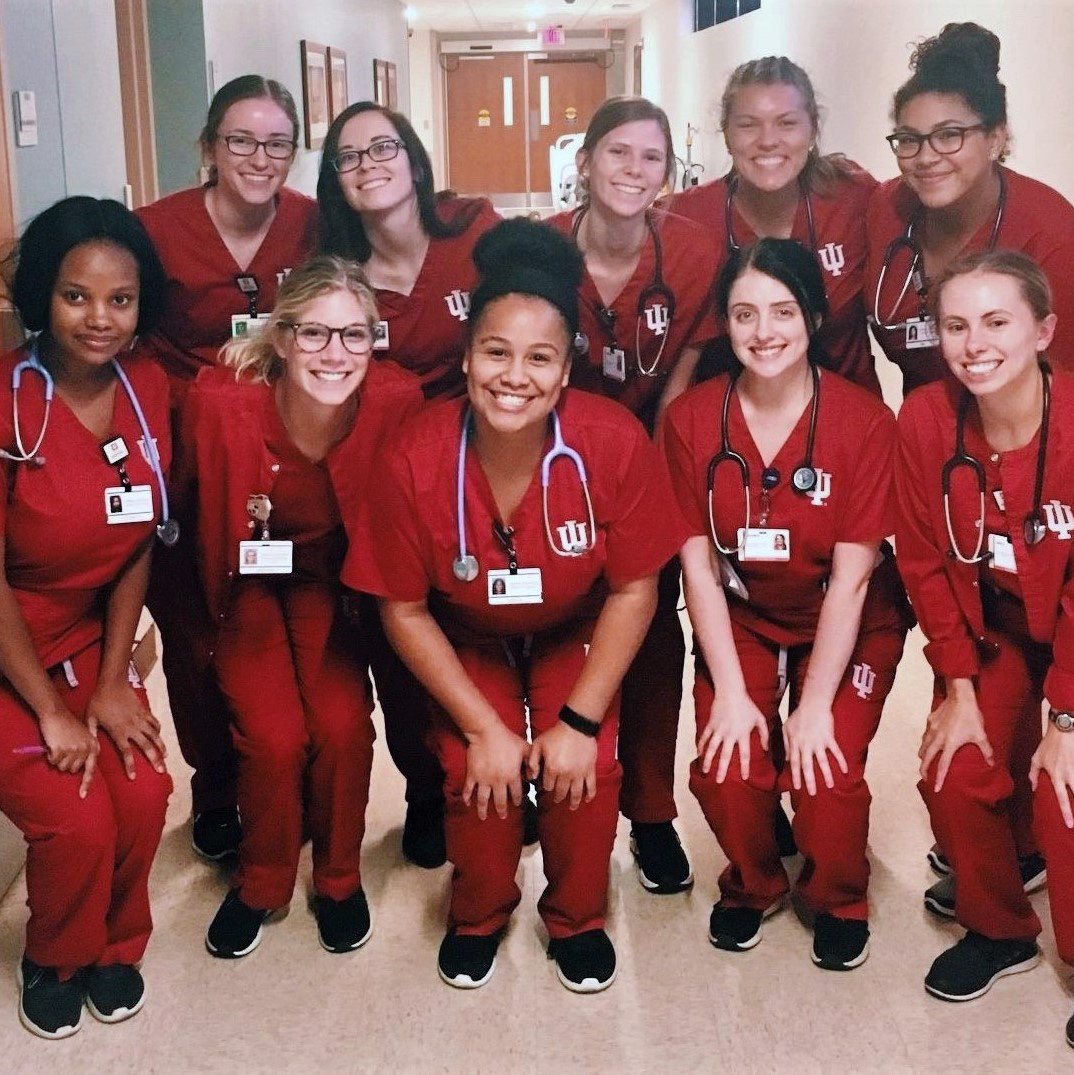 Group of students in red scrubs