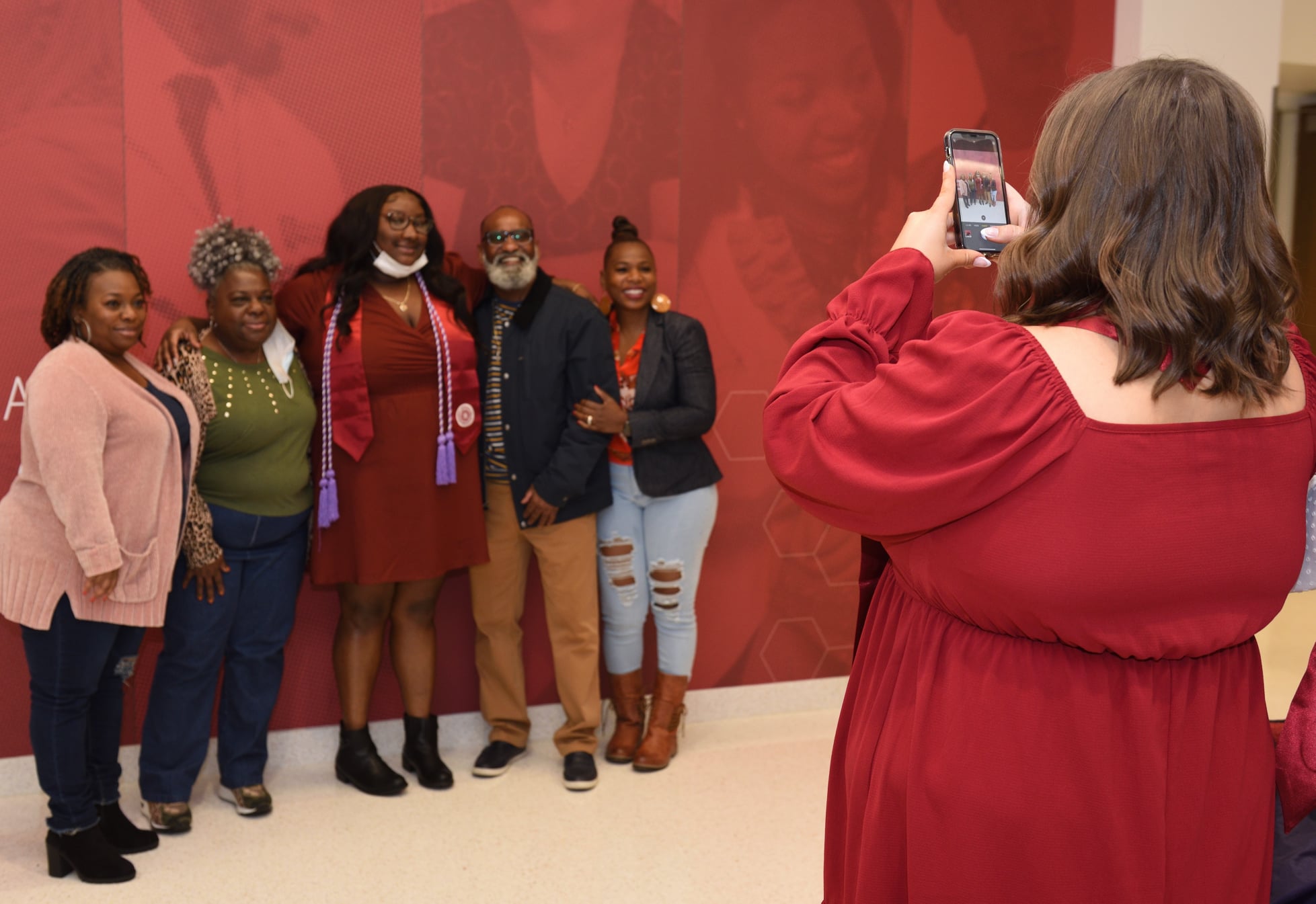 Woman taking a photo of a group at graduation