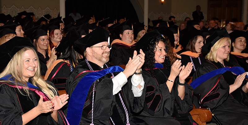 IU School of Nursing MSN, DNP, and PhD graduates clap during the 2024 Graduate Recognition Ceremony.